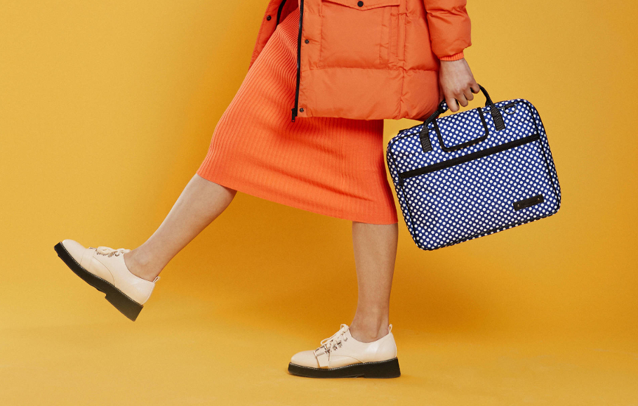 girl walking with blue polka music bag