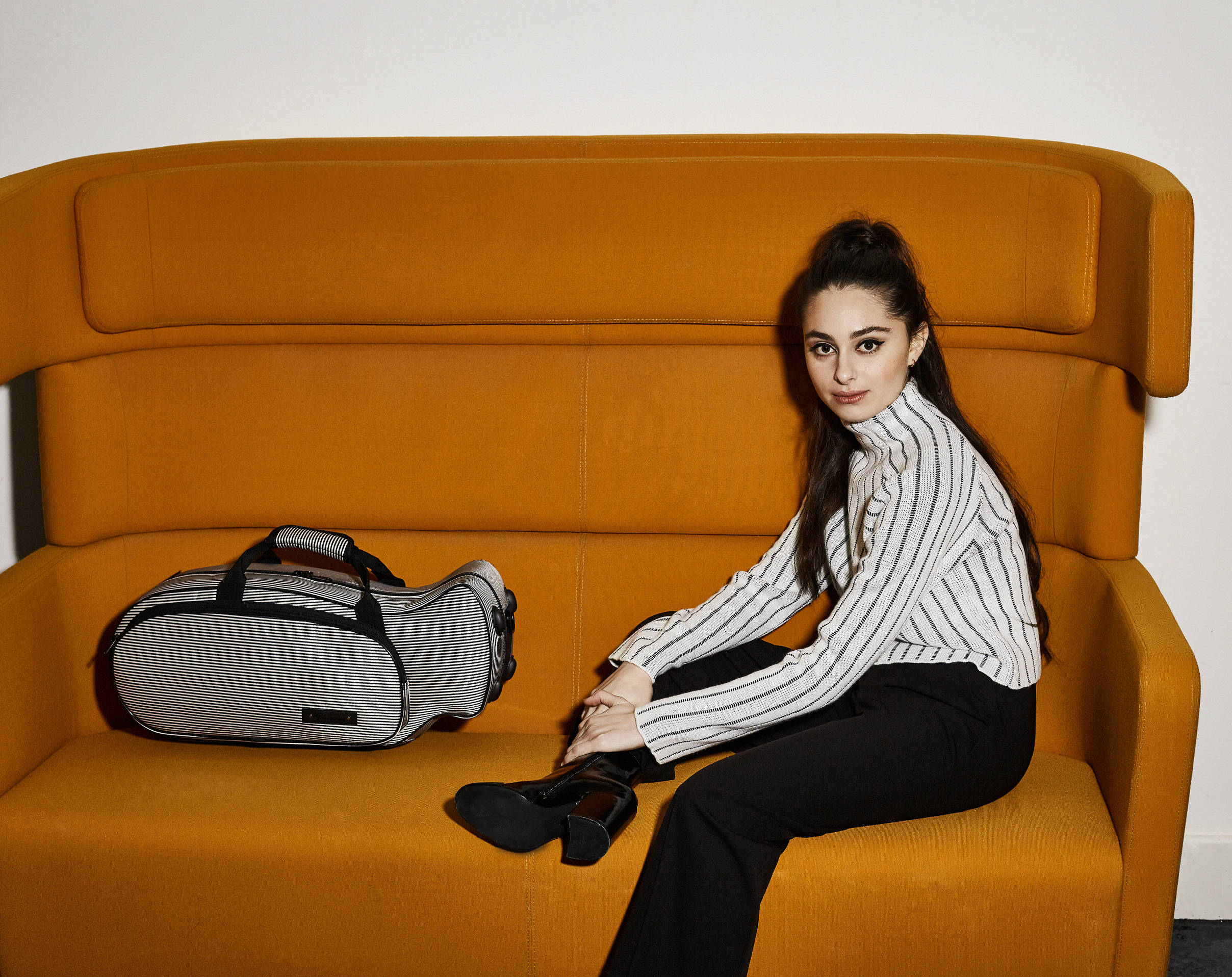 girl on sofa with trumpet case