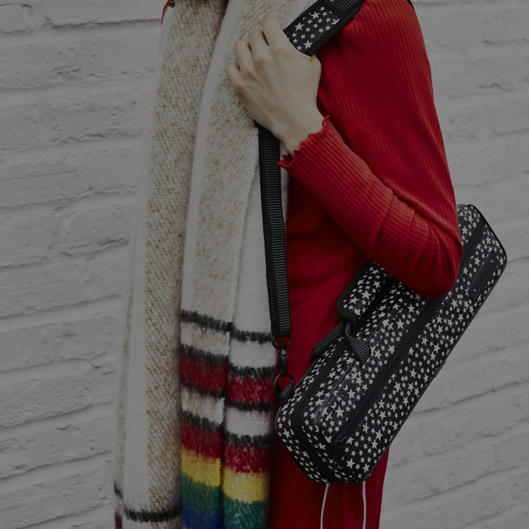 musician in red jumper carrying starry night flute case