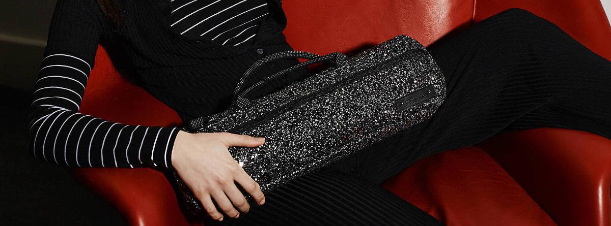 girl sat with glittery flute bag