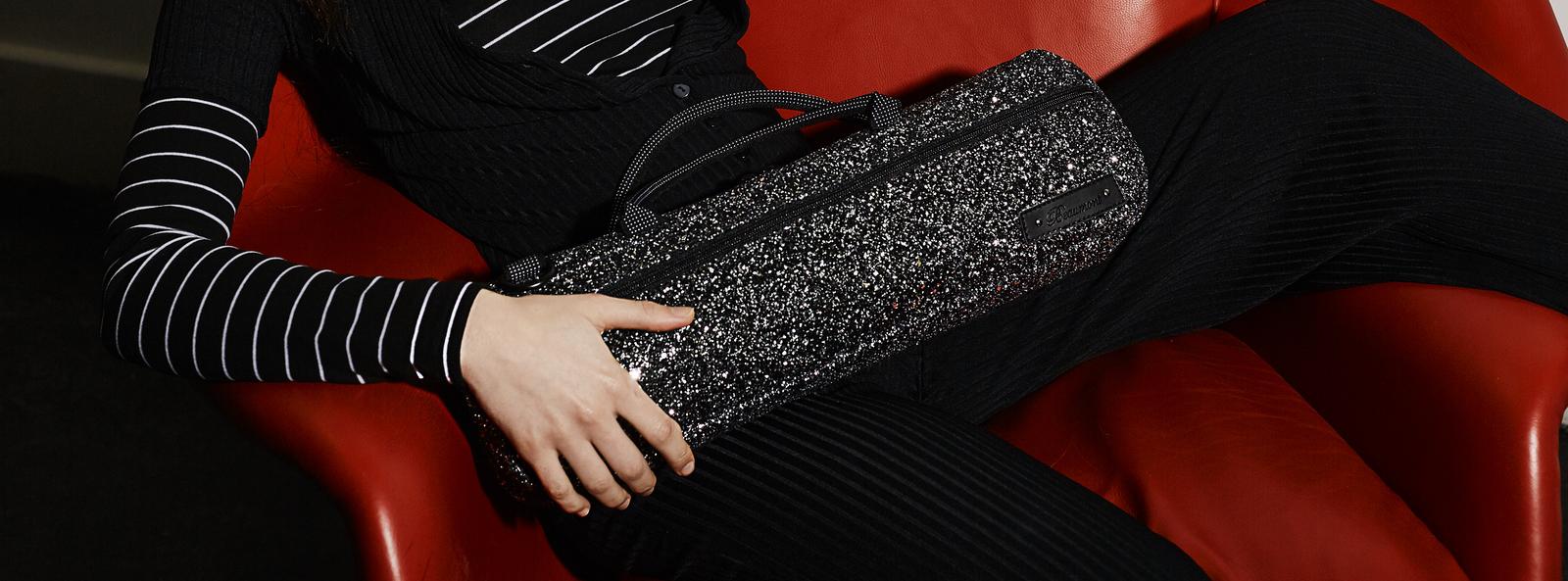 girl sat with glittery flute bag