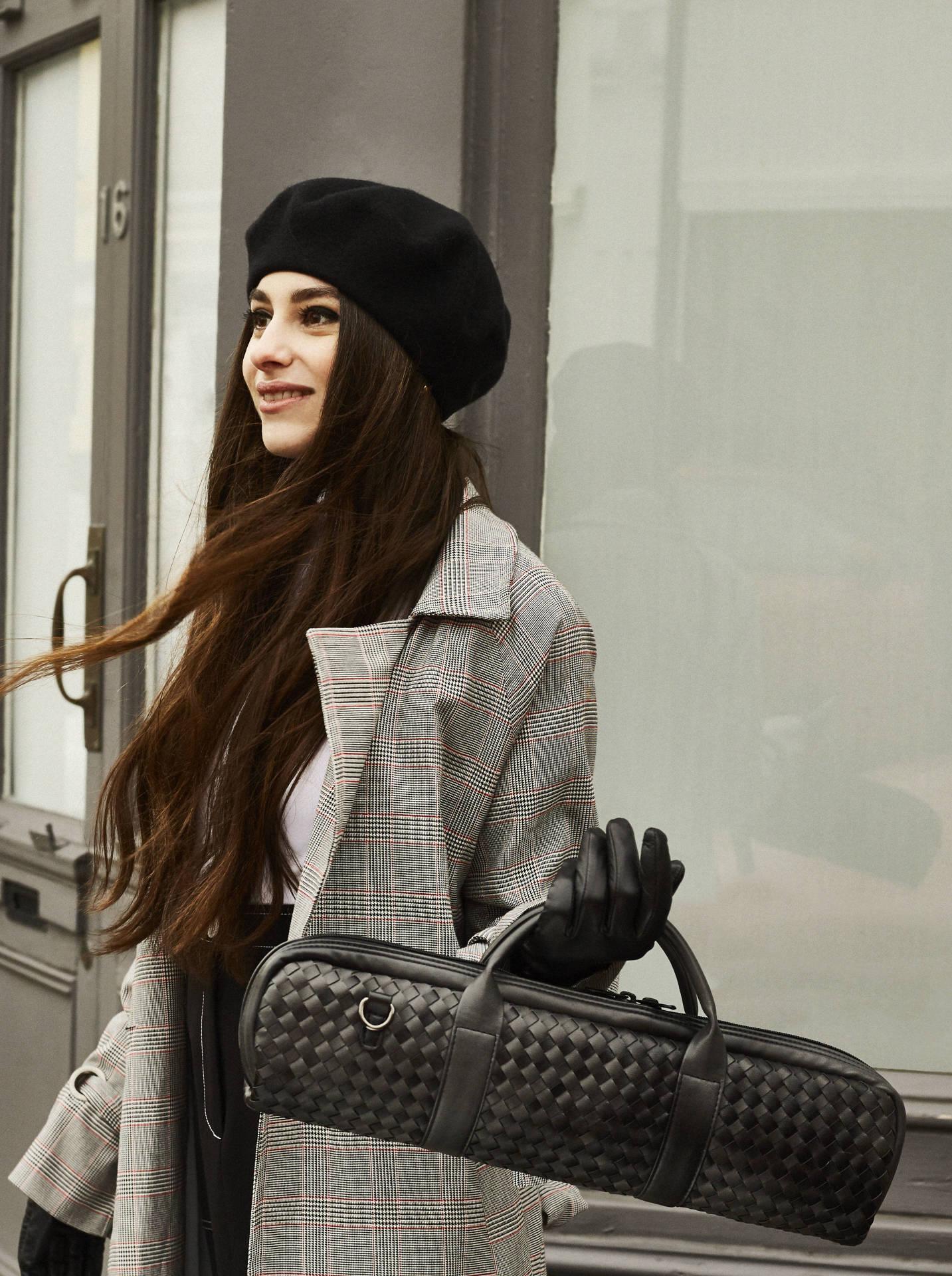 Girl Holding Black Weave Bag